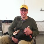 Photo of Adam Duerr holding a condor